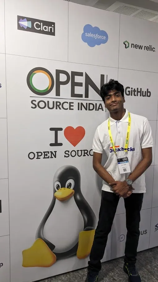 Standing at the Open Source India backdrop